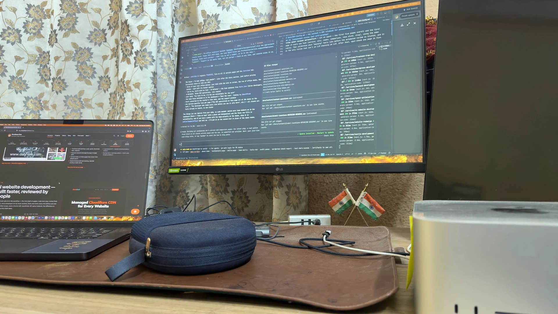 Code on a wide monitor with a laptop open beside it, on a desk in Kolkata, India