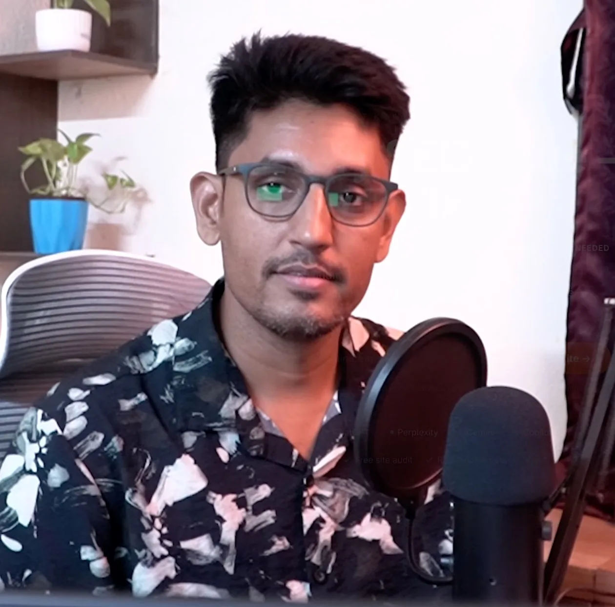 Microphone in front of him, Sandipan Das working at his own desk, Kolkata, India